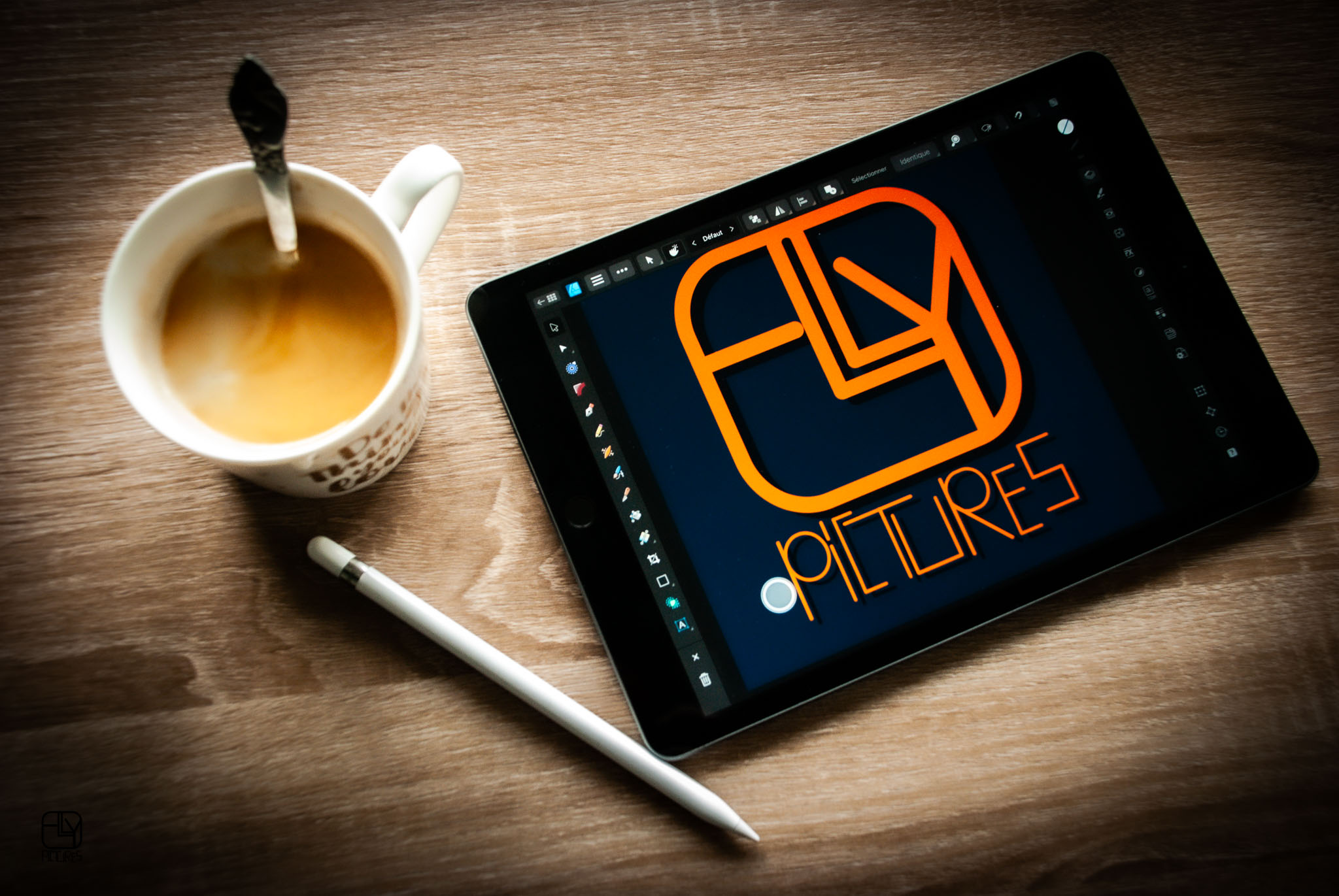 black ipad on brown wooden table